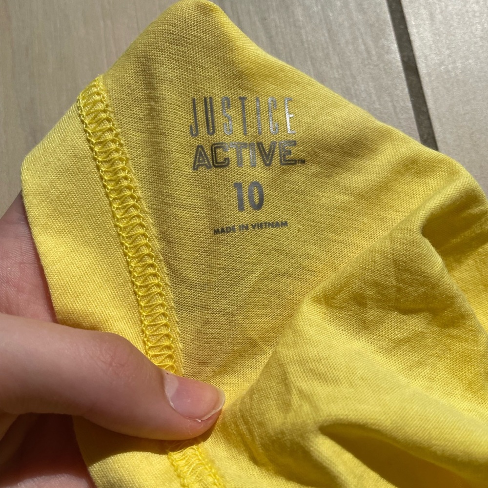 Justice yellow mesh back t-shirt.